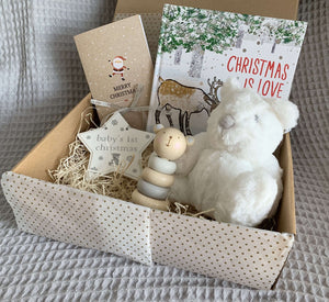 Baby's first Christmas gift box including baby's first christmas star tree decoration, christmas is love book, soft bear toy, wooden bear stacking toy and christmas card